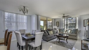 A spacious living room with a dining area, a sofa set, and a ceiling fan. - 3bed 2bath Luxury Yatch Club Condo at Aventura Fl, Parking Include! (Miami)