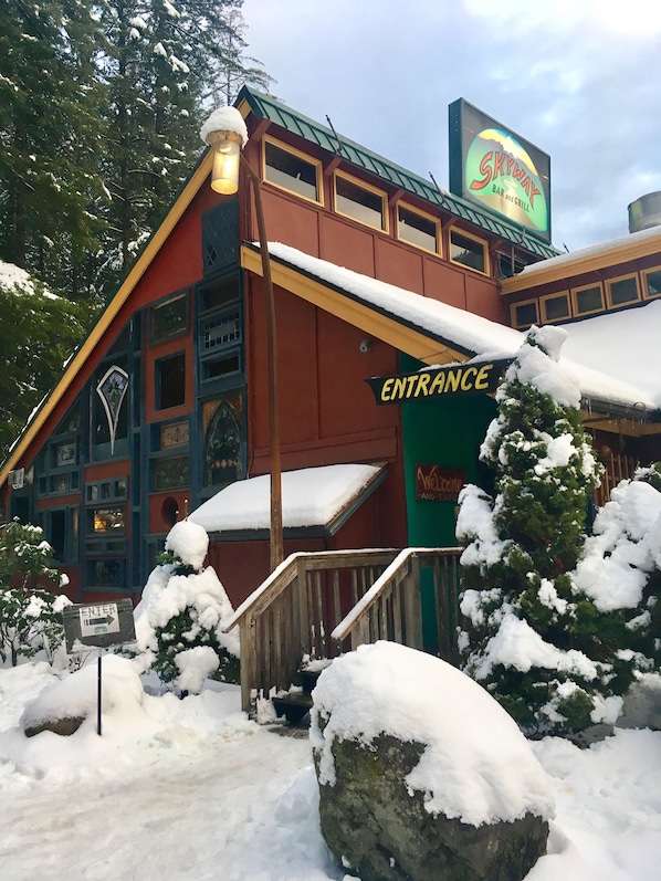 A building with a sign reading "Skyway Bar and Grill" and an "Entrance" sign.