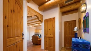 A hallway with wooden doors and a tiled floor.
