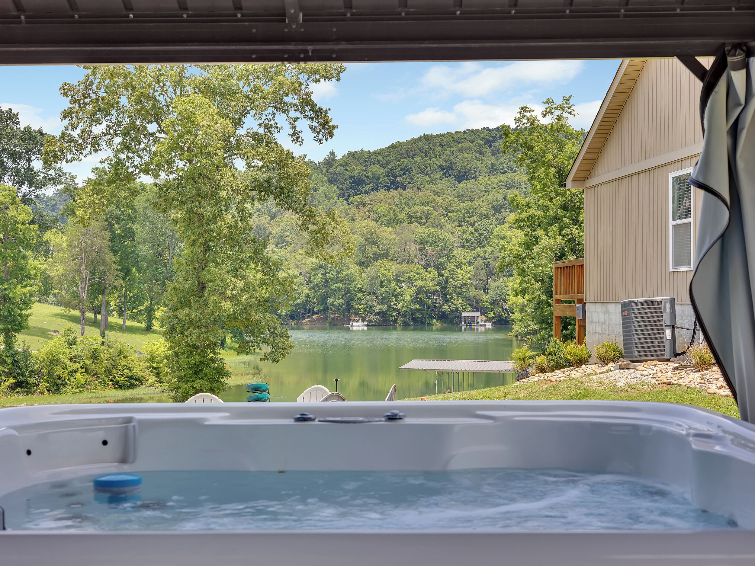A hot tub with a view of a lake and forest.