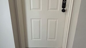 A white door with a numbered lock plate, a doorbell, and a black doormat with the word "hello". - Fun Under The Sun, Condo 3: You Need a St. George Get-away! (St George)