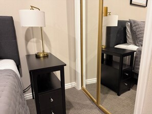 A hotel room with a bed, a bedside table with a lamp, a mirror, and a dresser. - Fun Under The Sun, Condo 3: You Need a St. George Get-away! (St George)