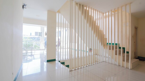 A spacious room with a staircase and a balcony. - Le Paris Syariah Residence (Tangerang)
