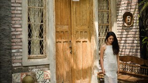A rustic building with a wooden door, a window with metal bars, and a number '5' on the wall. - Taman Nauli Bed & Breakfast (Tibubeneng)