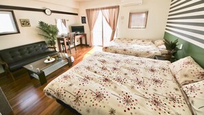 A hotel room with two beds, a sofa, a TV, and a desk. - Chura Gahna House Tsubogawa Naha (Naha)