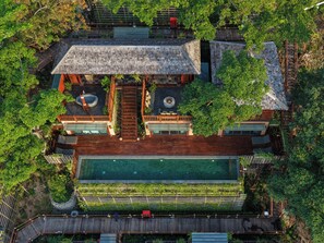 A large house with a swimming pool, wooden deck, and lush greenery. - Dinso Resort & Villas Phuket, Vignette Collection by IHG (Patong)