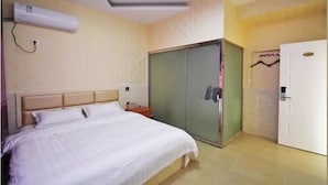 A hotel room with a bed, an air conditioning unit, a wardrobe, and a door. - LuHuai Hotel (Nanjing)