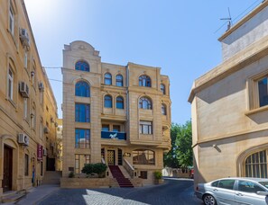 Un bâtiment historique doté d’une entrée principale, de nombreuses fenêtres et d’un escalier menant à l’entrée.
