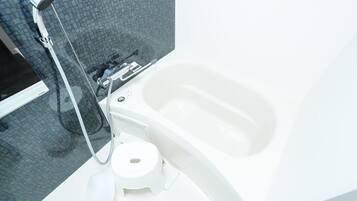 Combined shower/tub, free toiletries, hair dryer, slippers