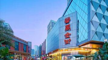 A modern building with large glass windows and a prominent sign with red characters.