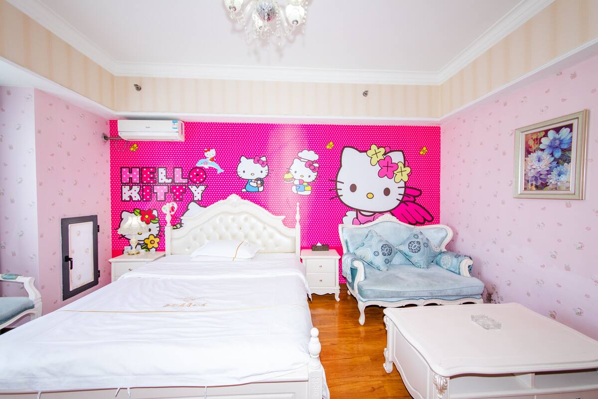 A pink-themed bedroom with a bed, a chair, a nightstand, and a dresser.