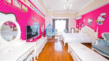 Un dormitorio con decoración rosa que incluye una cama, un tocador con espejo, un televisor y un sillón colgante.