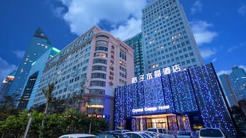 A hotel with a modern facade, multiple floors, and a prominent signage.