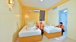Une chambre d’hôtel avec deux lits, une douche et une petite salle de bain.