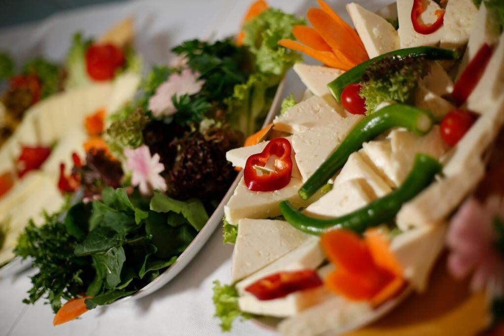 A variety of food items arranged on plates, including vegetables and possibly some meat or tofu.