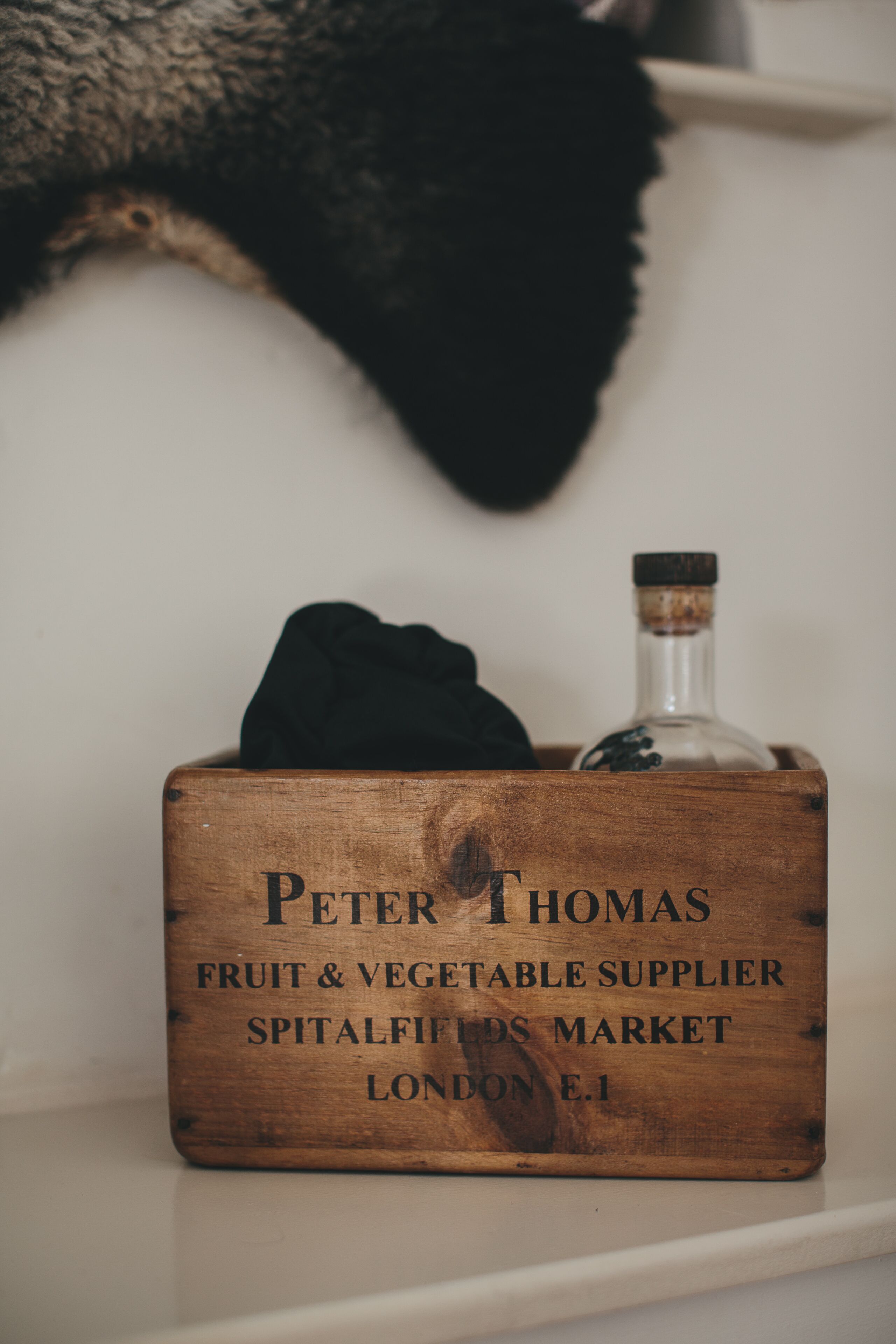 Una caja de madera con grabado que indica que es proveedor de frutas y verduras en el Mercado de Spitalfields, Londres.