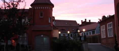 A brick building with a turret and a courtyard.
