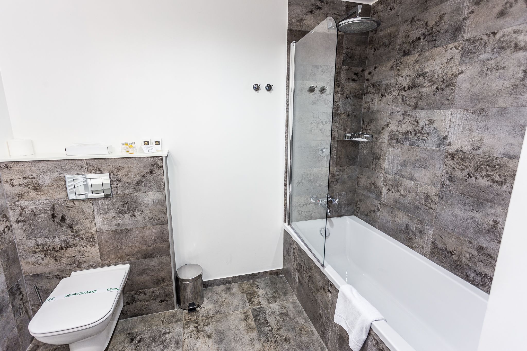 A bathroom with a toilet, a shower, and a bathtub.