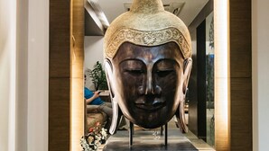 A modern interior with a large, ornate sculpture on a pedestal. - The Royale Senate Hebbal (Bengaluru)