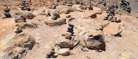 A rocky landscape with large boulders and a clear sky.
