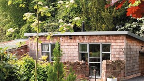 A small, single-story building with a brick exterior and large windows. - Pine Tree Lodge Bridgnorth (Bridgnorth)