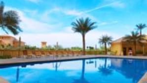 A clear blue pool surrounded by palm trees and buildings. - Piks Key - Sadaf 4 (Dubai)