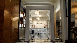 A modern hotel lobby with a checkered floor, a reception desk, and a chandelier. - The Connex Asoke (Bangkok)
