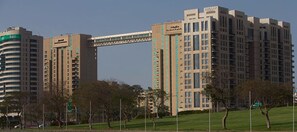 A high-rise building with multiple floors, large windows, and a prominent entrance.