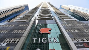 A modern building with the sign "TIGER" prominently displayed. - Piks Key- Marina Pinnacle (Dubai)