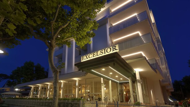 A modern hotel with a prominent "EXCELSIOR" sign, featuring a glass facade and multiple balconies. - Hotel Excelsior (Cervia)