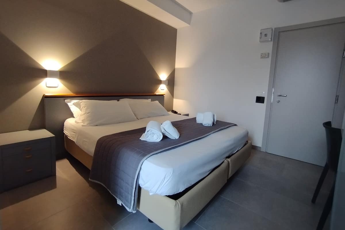 Ropa de cama hipoalergénica y caja de seguridad en la habitación