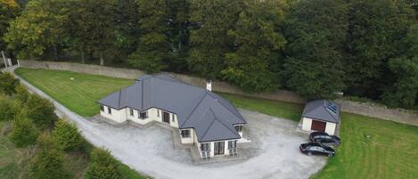 A large house with a spacious driveway and a garage.
