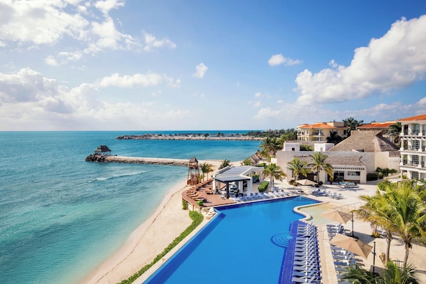 A resort with a large pool, beach, and ocean view. - Ventus at Marina El Cid Spa & Beach Resort - All Inclusive (Puerto Morelos)