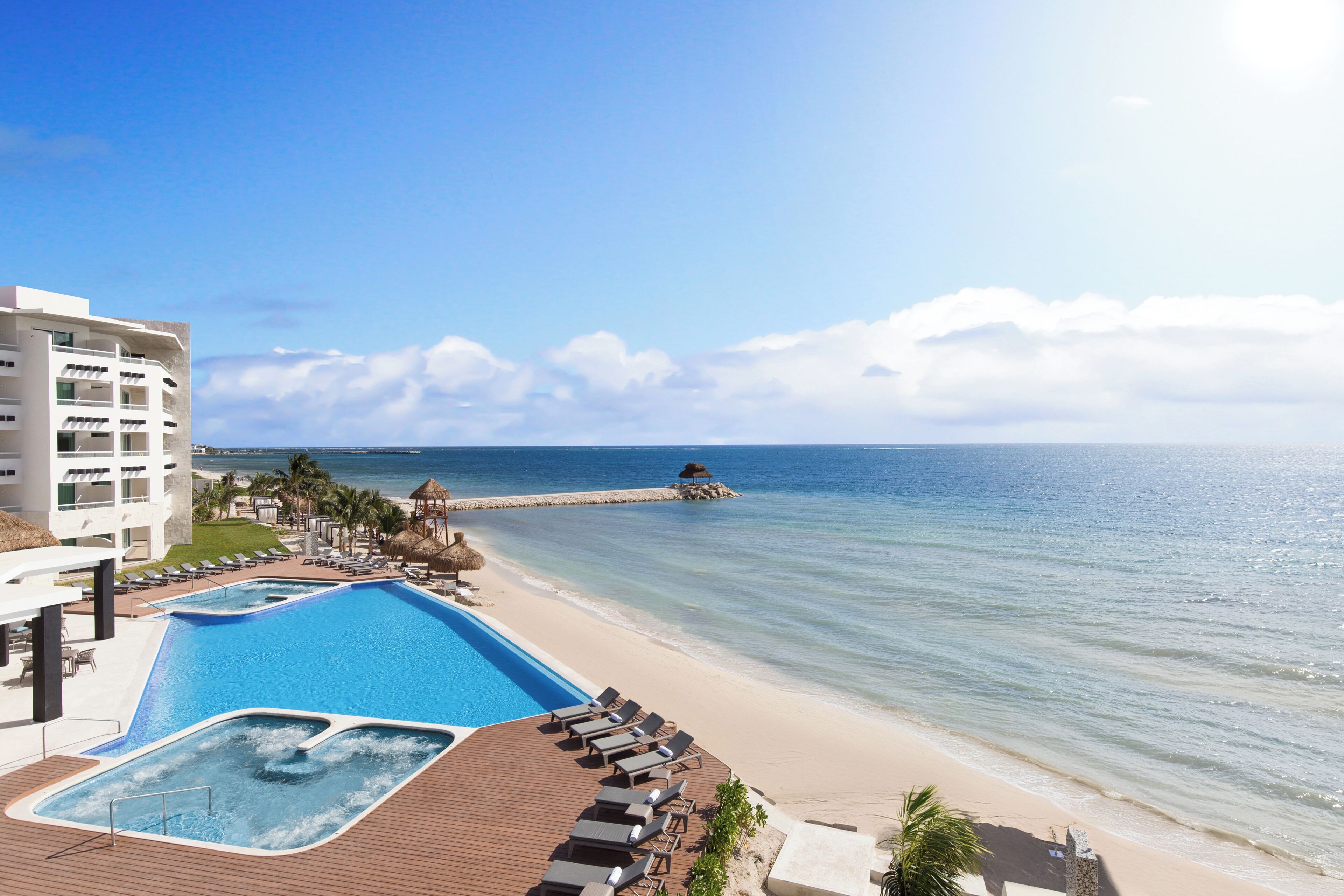 On the beach, white sand, sun-loungers, beach towels