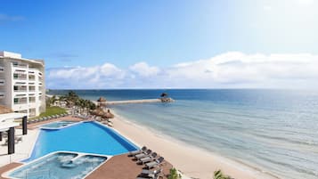 On the beach, white sand, sun-loungers, beach towels