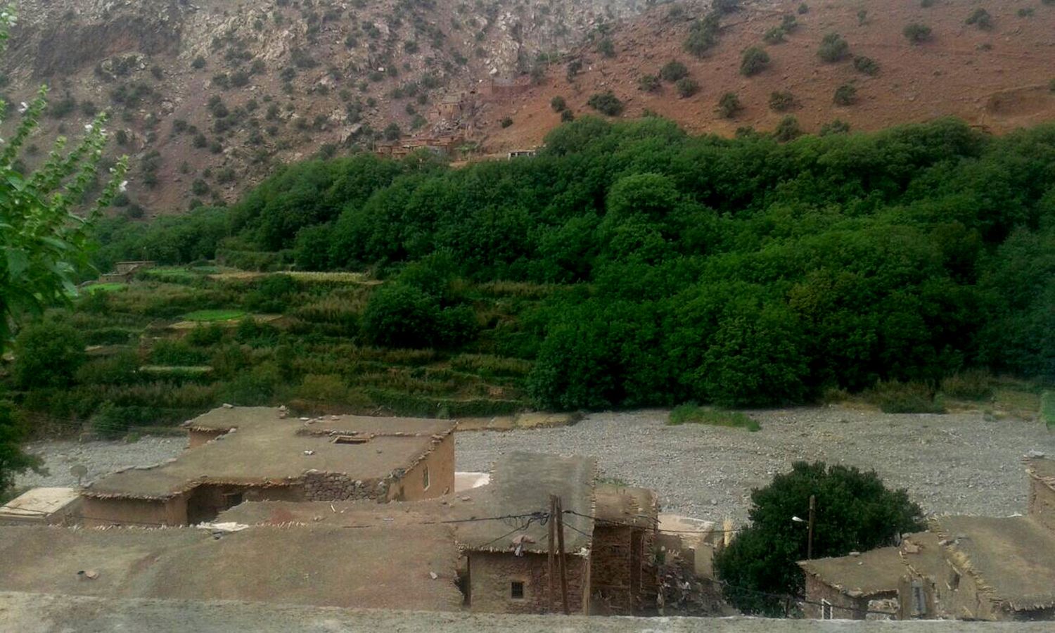 A rural village with terraced fields and traditional buildings.