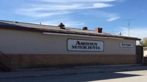 A building labeled "Ashern Motor Hotel" with a sign indicating "B&B" and a visible antenna on the roof.