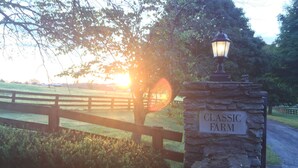 A stone sign with "CLASSIC FARM" written on it, a wooden fence, and a lamp post. - The B & B at Queenslake (Georgetown)