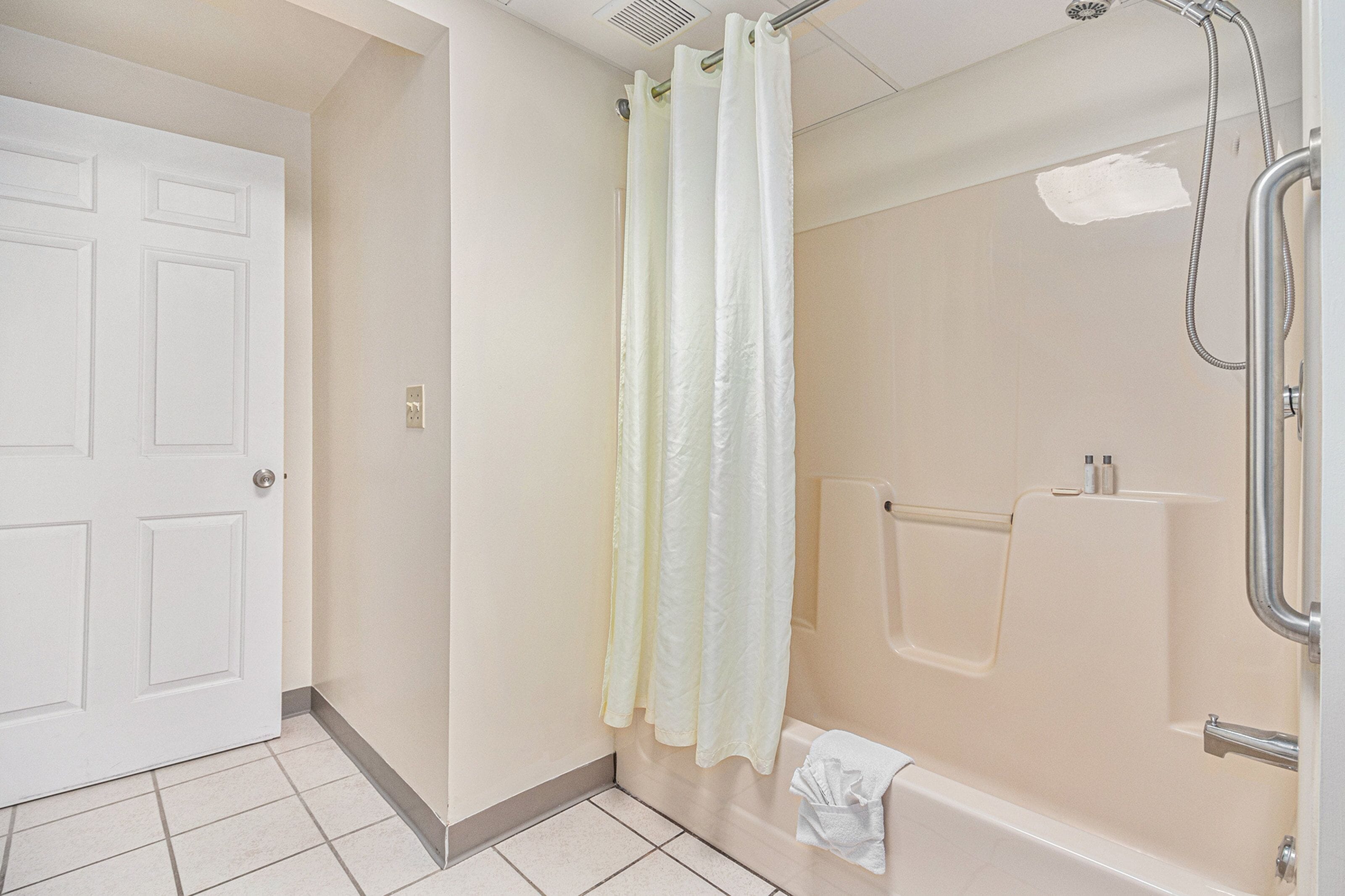 A bathroom with a shower, a bathtub, and a toilet.