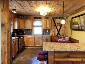 Enjoy a hearty breakfast at the kitchen's central island, where a large window lets in plenty of natural light.