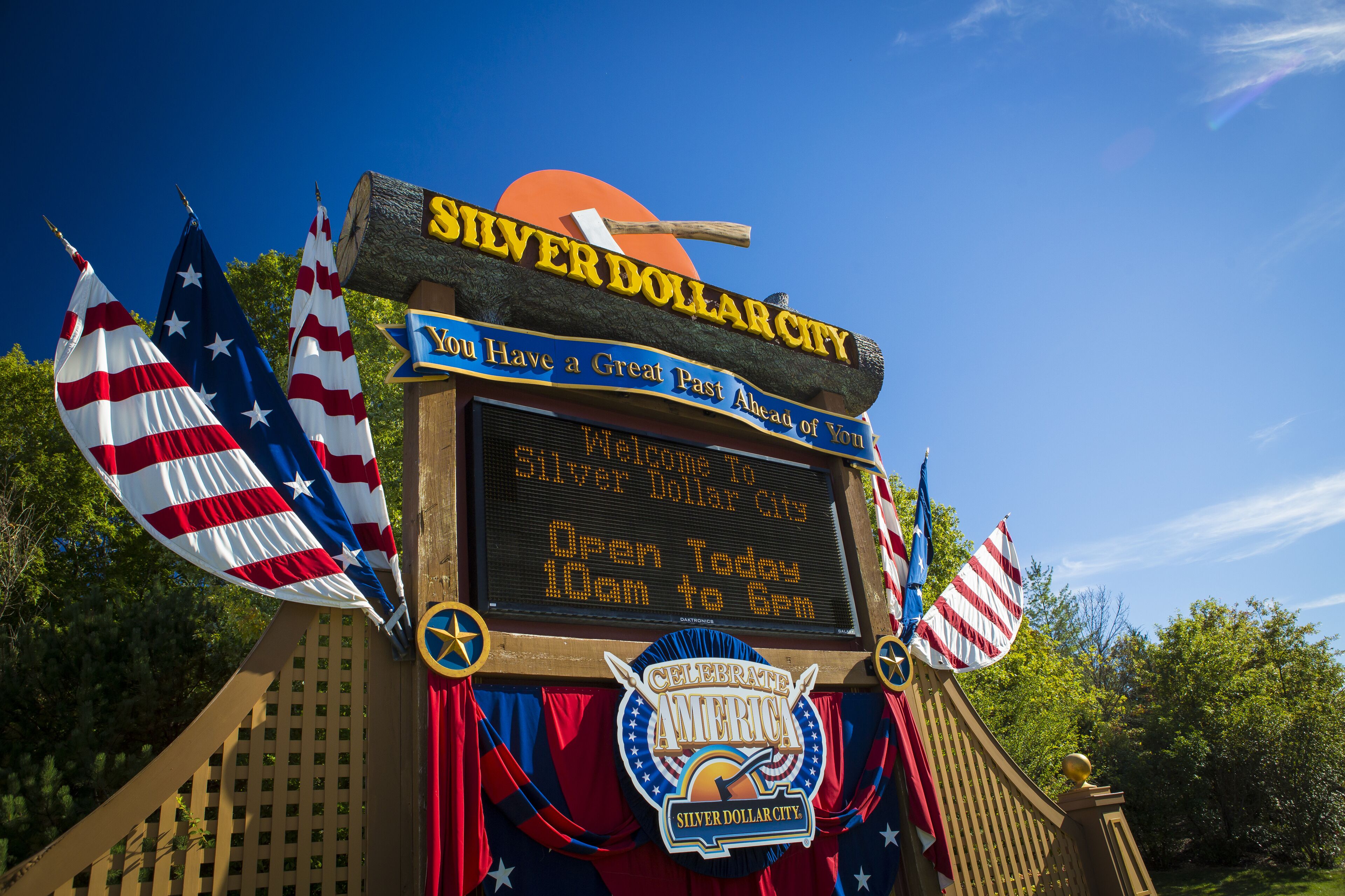 A sign with 'Silver Dollar City' and a message about a past event.