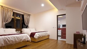 A hotel room with two beds, wooden flooring, a TV, and a minibar. - Sin Ging Hong Resort (Lugu)