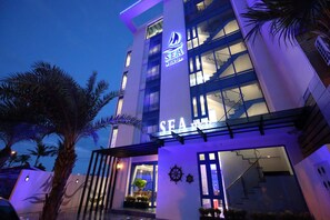 A modern hotel with a prominent sign reading "SEA B&B".