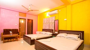 A hotel room with two beds, a ceiling fan, an air conditioning unit, a sofa, and a small table. - Fanush Resort (Bandarban)