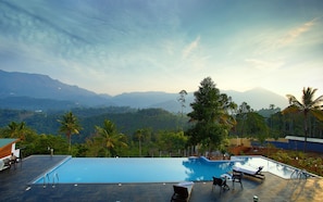 Outdoor pool, open 7:00 AM to 7:00 PM, pool umbrellas, sun loungers - The Leaf Munnar Resort (Devikolam)