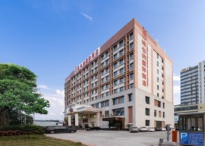 A multi-story hotel with a prominent entrance and signage indicating it is a hotel.
