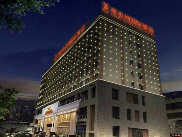 A multi-story hotel with a prominent sign at the top.