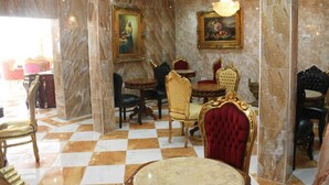 A luxurious dining area with marble walls, ornate chairs, and chandeliers. - Grand Emperor Hotel (Lekki)