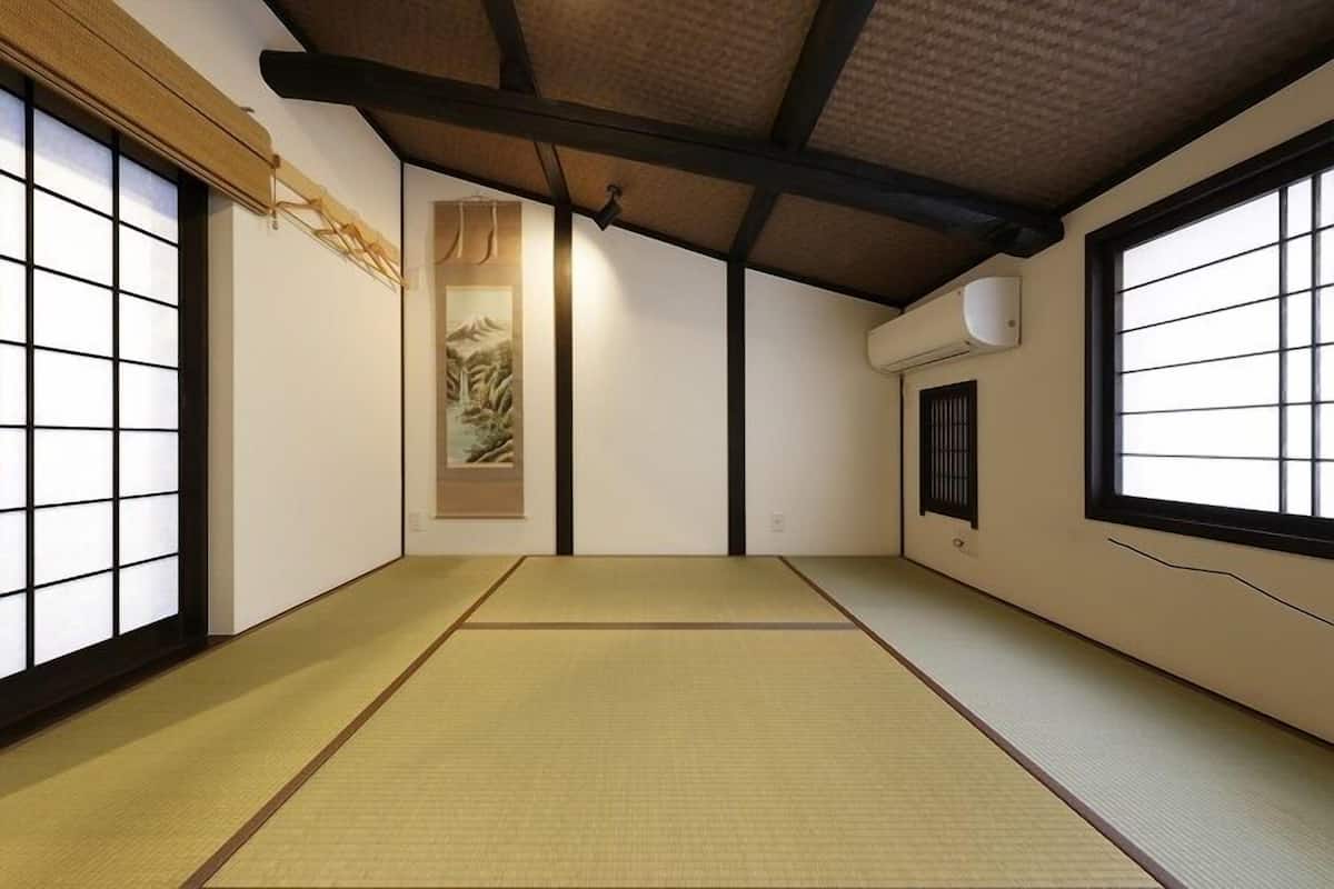 A traditional Japanese room with tatami flooring, shoji screens, and a sliding door.