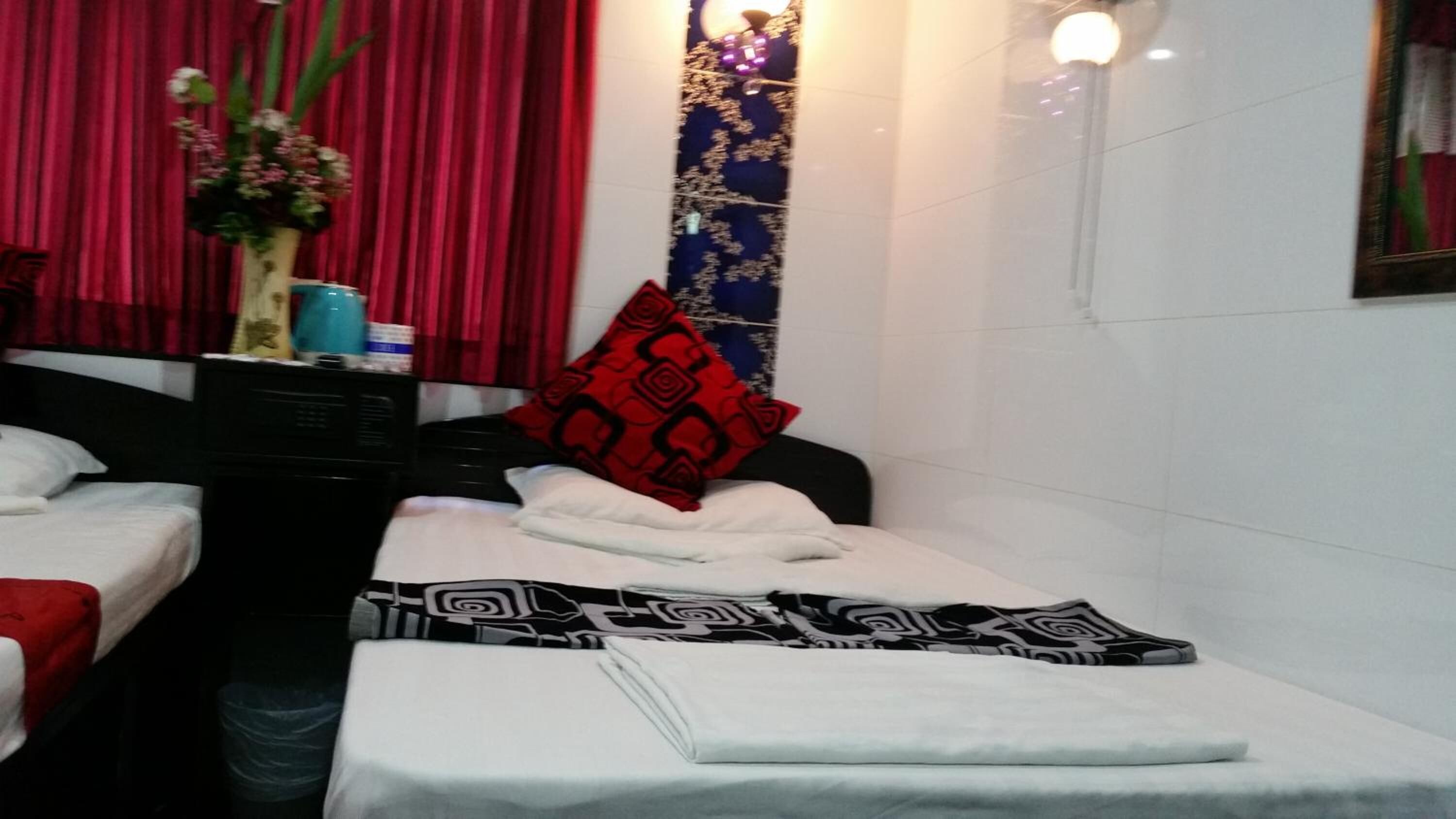A spa room with two massage tables, each with a towel and a patterned pillow.